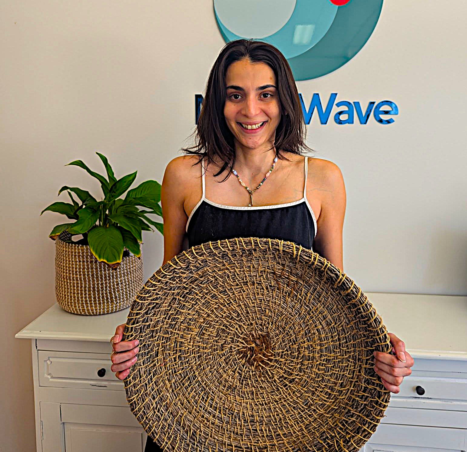 Occupational Therapist holding woven basket for neurodivergent women flow state art group